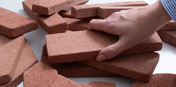 Hand holding one of many terracotta shapes